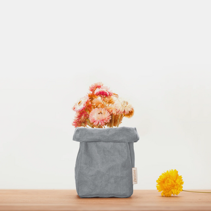 forstina small washable paper bag with gray color | stone color on the desk, container yellow flower.